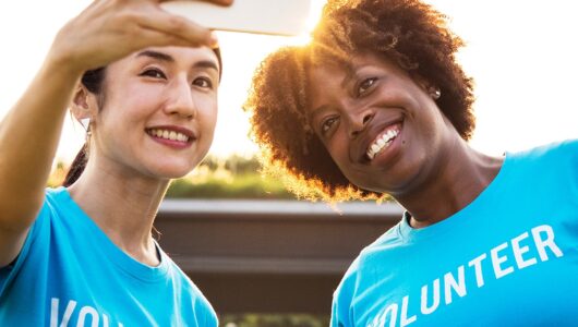 Two volunteer persons taking selfie