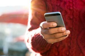 Man performing Google search on mobile device.